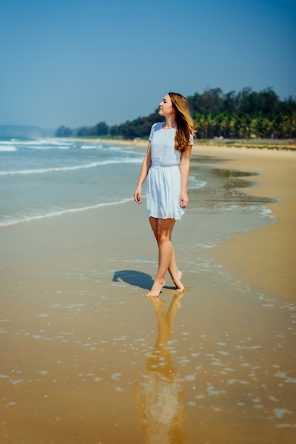 Premium Photo | Beautiful girl in white dress enjoy and relax on the beach