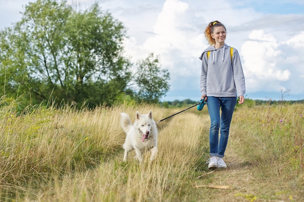 Premium Photo | Beautiful girl with white dog walking