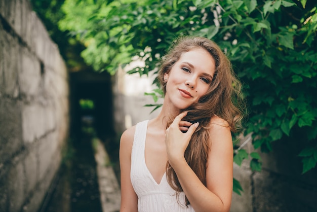 Beautiful Happy Girl With Curly Natural Hair In White Dress Near
