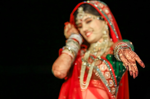 Premium Photo | Beautiful indian bride showing mehndi hand wearing sari ...