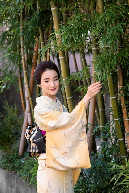 Beautiful japanese woman in a kimono outdoors Free Photo