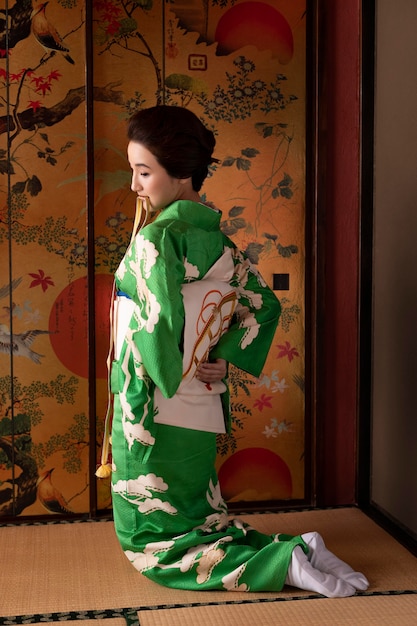 Free Photo | Beautiful japanese woman putting on an obi