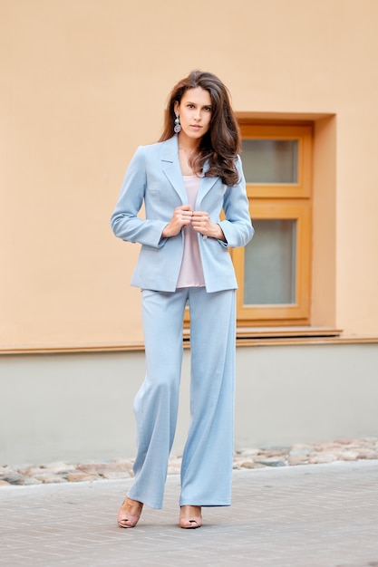 Beautiful lady in skyblue pantsuit on the street Premium Photo