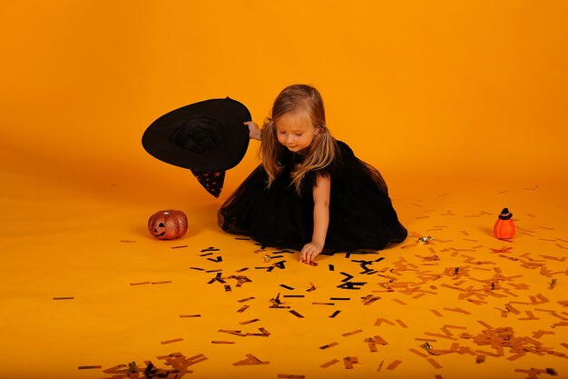 Premium Photo Beautiful Little Blonde Girl In A Black Dress And A Witch Hat Halloween 5292