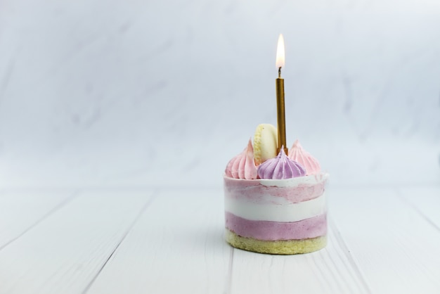Premium Photo | Beautiful little pink cake with cream with a candle