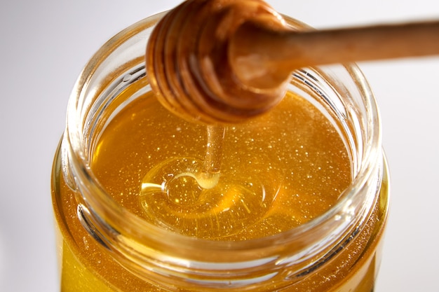 Premium Photo | Beautiful macro image of honey in a jar from above ...