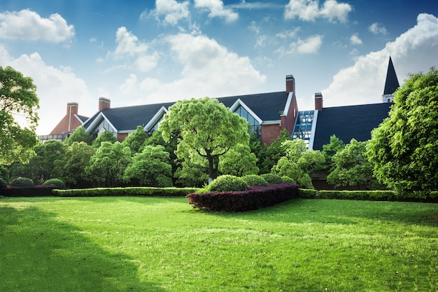 Beautiful modern house in cement, view from the garden. Free Photo