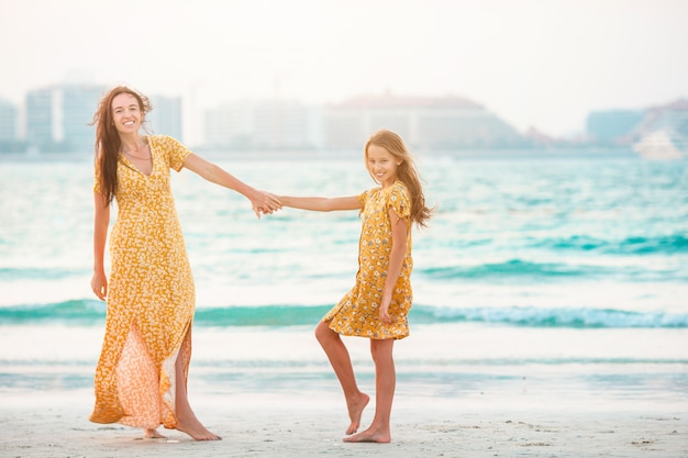 Premium Photo Beautiful Mother And Daughter At The Beach Enjoying Summer Vacation 