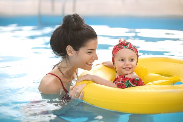 Premium Photo Beautiful Mother And Daughter Swimming In A Swimming Pool