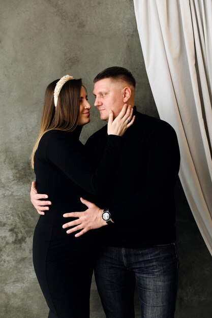 Premium Photo Beautiful Pregnant Couple Dressed In Beautiful Black