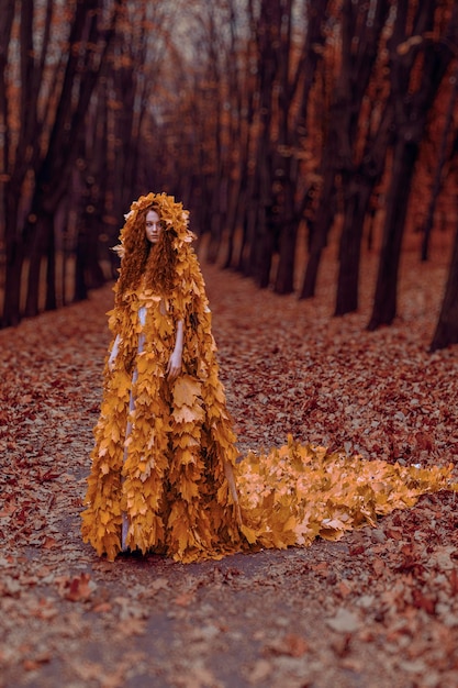 Premium Photo | Beautiful redhead girl as a autumn in leaf cloak in forest