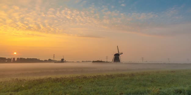 free-photo-beautiful-shot-of-mills-in-the-field-with-the-sun-rising