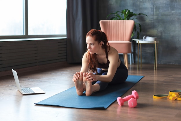 premium-photo-beautiful-slim-sporty-woman-is-stretching-while-sitting