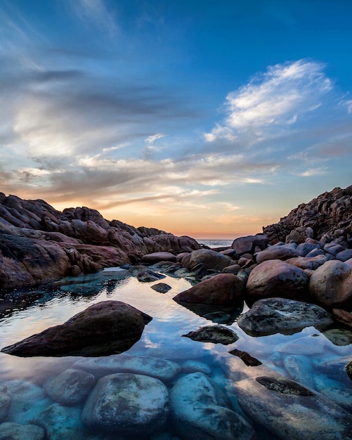 Free Photo | Beautiful sunset at the beach with rocks