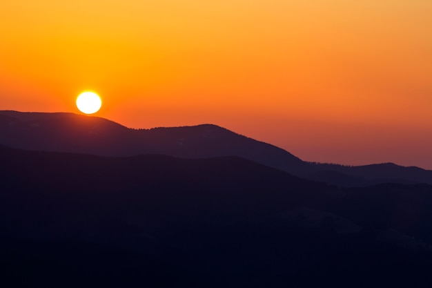 Premium Photo Beautiful Sunset In Mountains Wide Panorama View Of Big Bright White Sun In Dramatic Orange Sky Over Dark Mountain Range Landscape At Sunset Or Sunrise Beauty Of Nature Concept