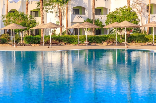 Premium Photo | Beautiful swimming pool the luxury hotel and palm trees