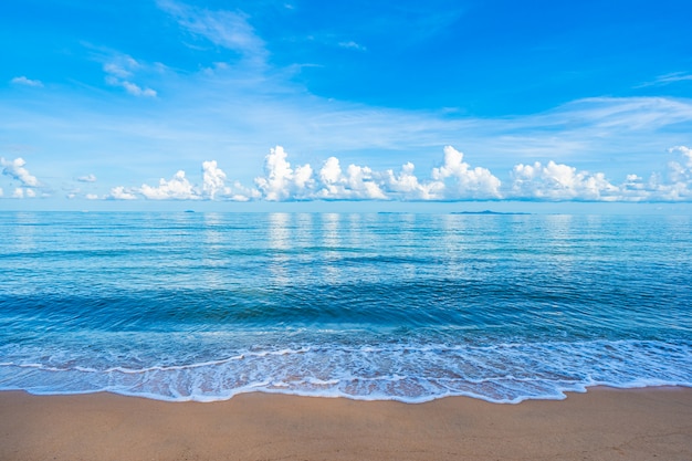 Beautiful tropical beach sea ocean with white cloud blue sky and copyspace Free Photo