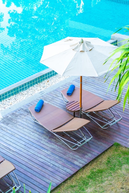 Beautiful Umbrella And Chair Around Swimming Pool In Hotel