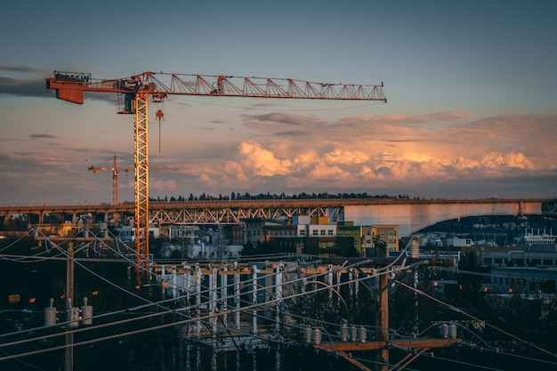 Beautiful view of a construction site in a city during sunset Free Photo