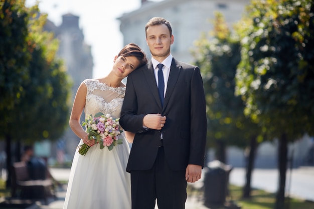 Premium Photo | Beautiful wedding couple posing in the old town.