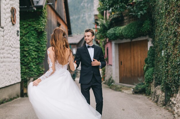 A Beautiful Wedding Couple Walks In A Fairy Austrian Town