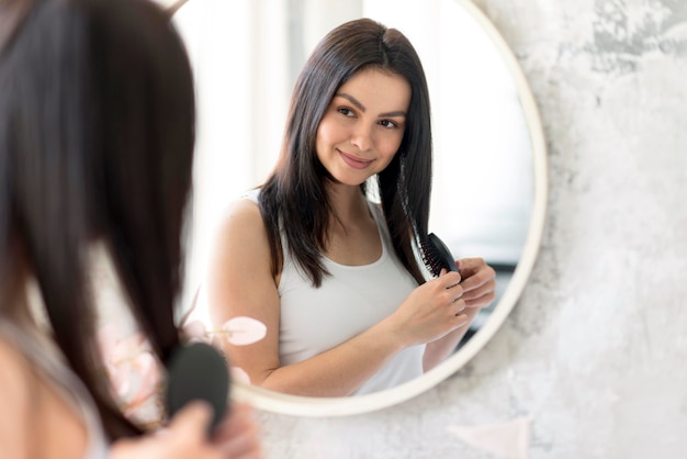 Premium Photo | Beautiful woman arranging herself in the mirror
