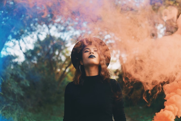 Premium Photo | Beautiful woman in black dress standing in forest.