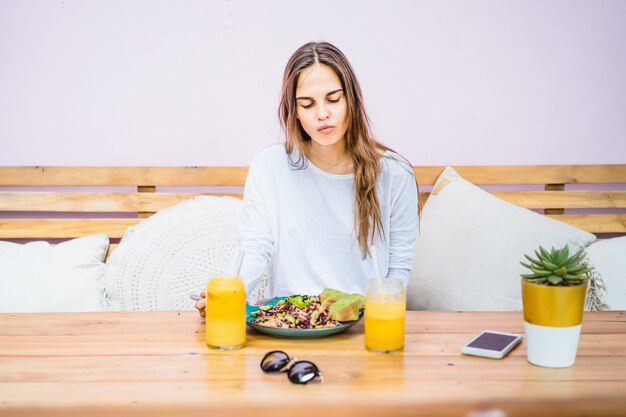 Premium Photo | A beautiful woman has breakfast in a stylish cafe