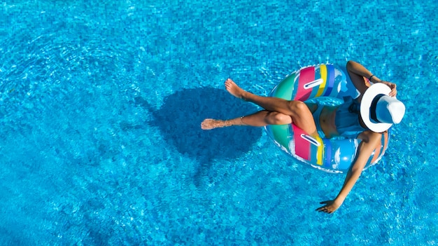 Premium Photo | Beautiful woman in hat in swimming pool aerial top view ...