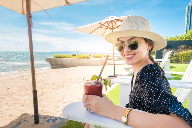 Premium Photo Beautiful Woman Is Relaxing On The Beach Under Umbrella