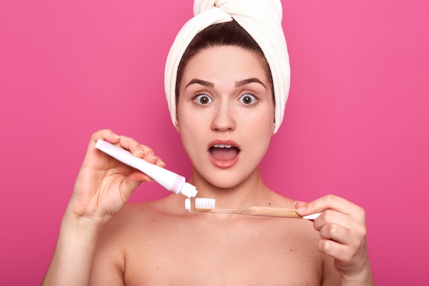 Beautiful Woman Putting Toothpaste On Toothbrush Has Astionished