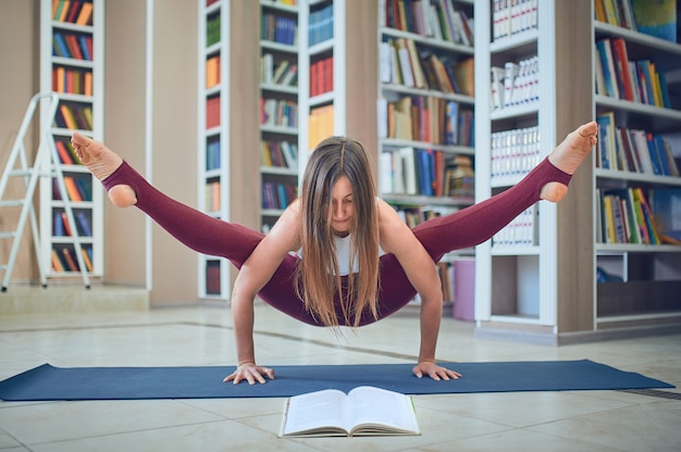 Premium Photo Beautiful Woman Reading Book And Practices Handstand