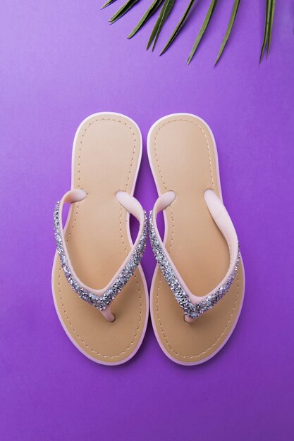 Premium Photo | Beautiful woman's beach flip-flops on the violet or ...