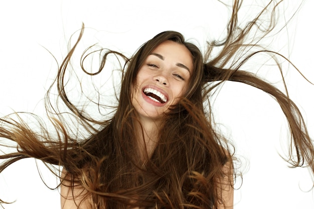 Beautiful woman shakes her hair on white background Free Photo