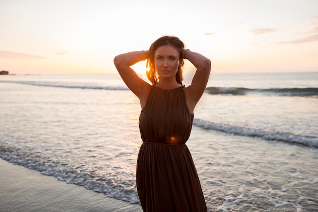 Premium Photo | Beautiful woman on sunset background