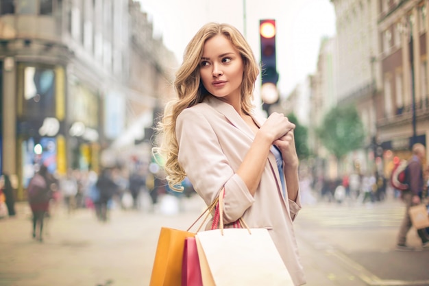 https://image.freepik.com/free-photo/beautiful-woman-walking-in-the-street-holding-shopping-bags_142605-694.jpg