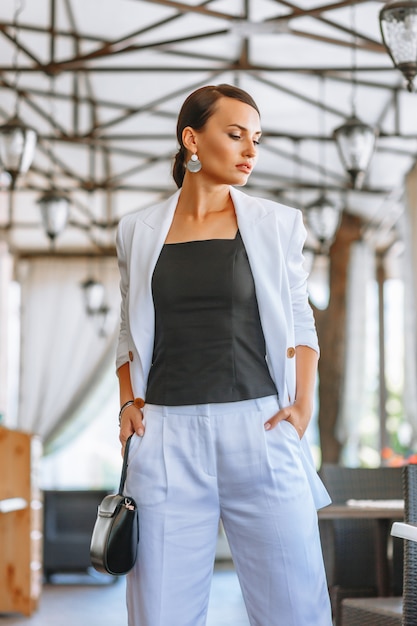 Premium Photo | Beautiful woman in a white business suit in a restaurant