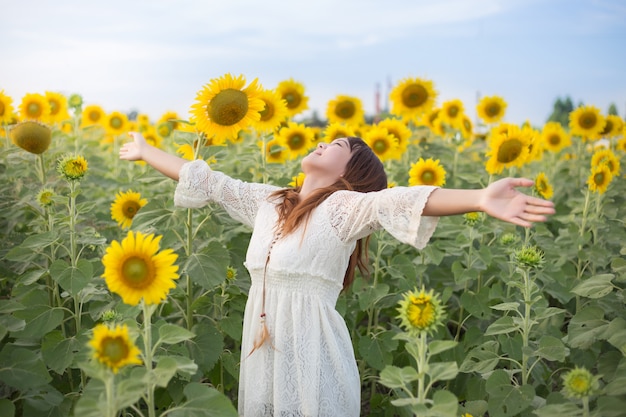 Premium Photo | Beautiful woman in a white dress on a field of summer ...