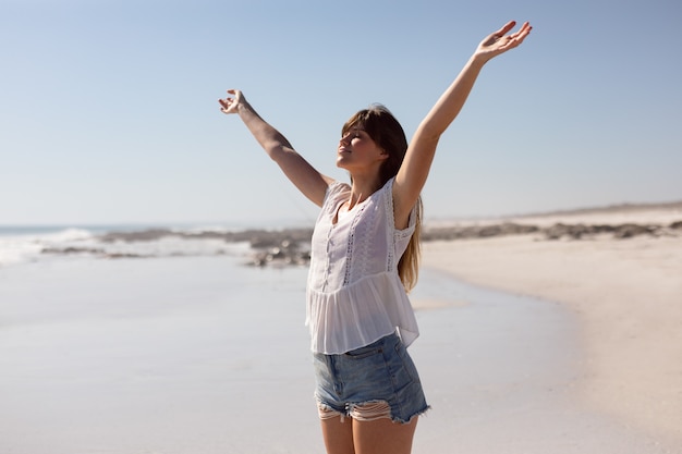 Free Photo | Beautiful woman with arms stretched out standing on beach ...