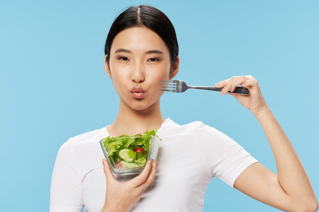Premium Photo | Beautiful young asian woman eating a healthy salad