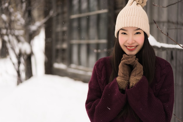 Beautiful young asian woman smiling happy for travel in snow winter ...