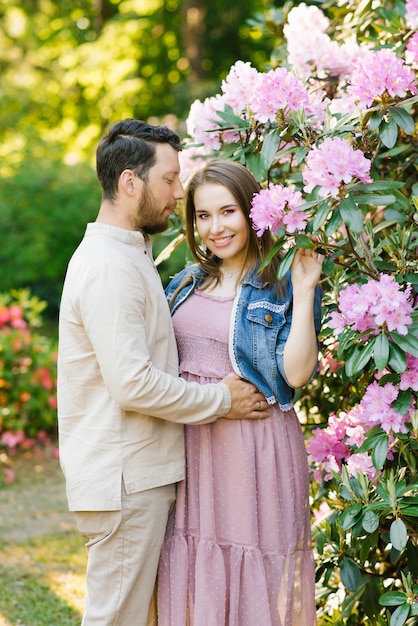 Premium Photo Beautiful Young Couple In Love Husband And Wife Hug Each Other Enjoying The Spring Summer Day Walking In The Park Happy And Harmonious Relationship Newlyweds