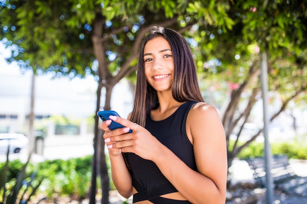 Free Photo Beautiful Young Happy Latin Woman Texting On Mobile Phone