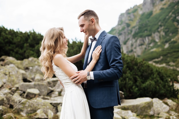 https://image.freepik.com/free-photo/beautiful-young-wedding-couple-groom-bride-standing-green-slope-hill-sunset-carpathian-mountains_170362-520.jpg