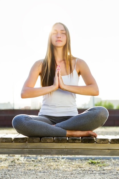 Beautiful young woman doing yoga in the street. Photo | Free Download