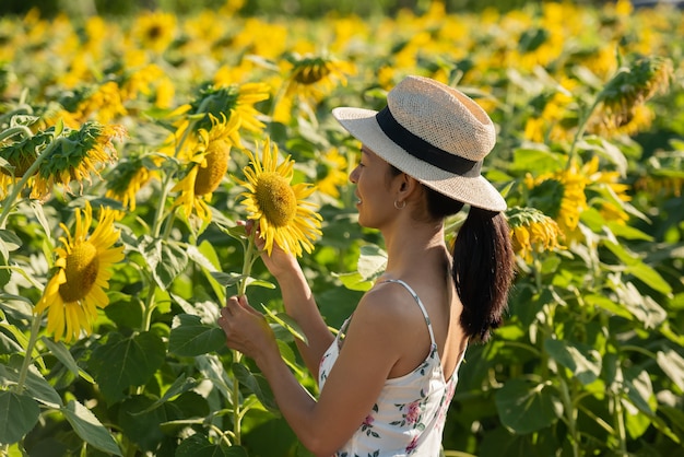 Free Photo | Beautiful young woman in a field of sunflowers in a white ...