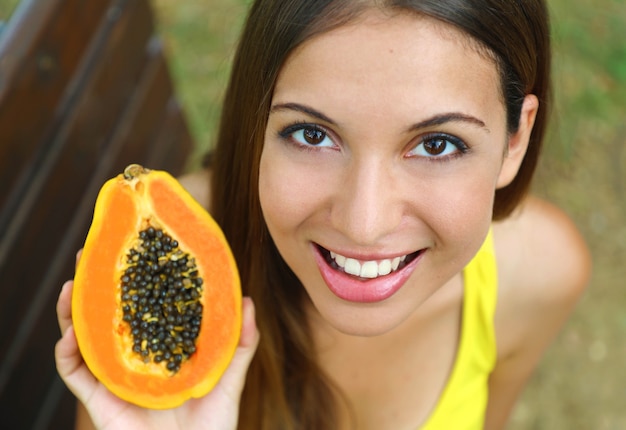 Premium Photo | Beautiful young woman holding papaya fruit
