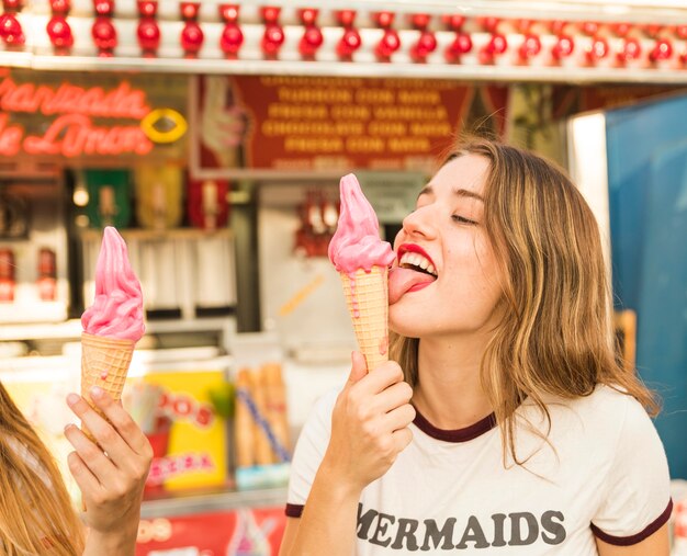 Beautiful Young Woman Licking Yummy Ice Cream Free Photo