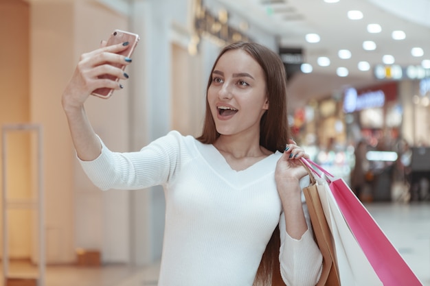 Premium Photo | Beautiful young woman shopping at the local mall