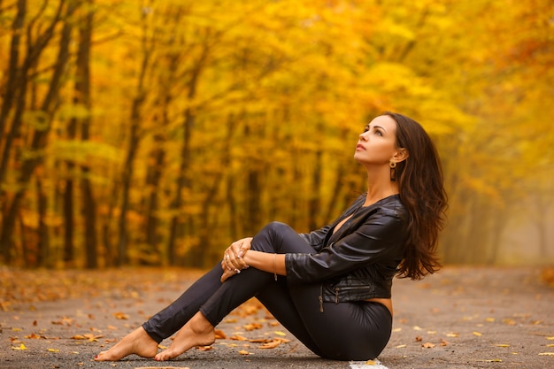 https://image.freepik.com/free-photo/beautiful-young-woman-sitting-autumn-park-road-black_78492-144.jpg
